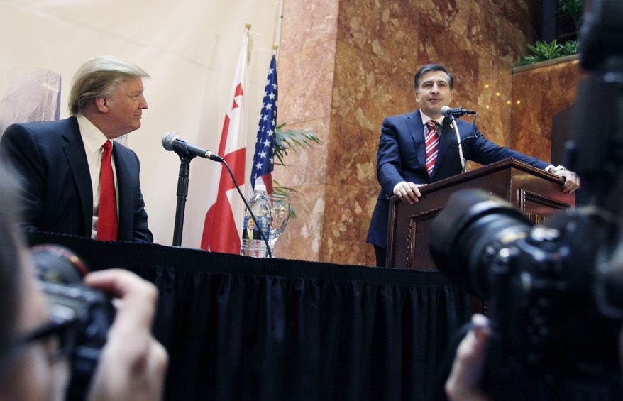 Real estate developer Donald Trump (left) listens as Georgian President Mikhail Saakashvili speaks during a joint news conference in New York on Thursday, March 10, 2011. Mr. Trump and a Georgian development group have agreed to build a Trump Tower in Georgia. Mr. Trump indicated he seriously is considering a run for the U.S. presidency. (AP Photo/Mark Lennihan)
