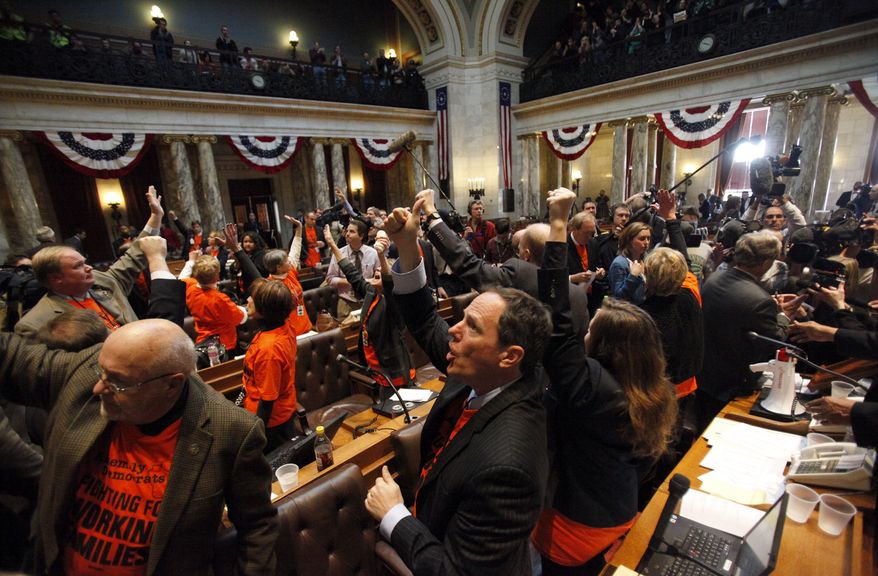 **FILE** State Rep. Jon Richards (center), Milwaukee Democrat, and other Assembly Democrats thank protesters in the gallery on March 10, 2011, after they were unable to stop the Republican majority from voting on, and passing, the budget repair bill at the state Capitol in Madison, Wis. (Associated Press/Wisconsin State Journal, Michael P. King)