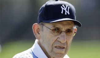 FILE - This Feb. 23, 2011, file photo shows New York Yankees Hall of Fame catcher Yogi Berra during a Yankees baseball spring training workout, at Steinbrenner Field in Tampa, Fla. Berra has been taken in an ambulance from the Yankees spring training complex to a hospital following a fall. Yankees general manager Brian Cashman said the 85-year-old former catcher caught one of his sneakers on the carpet in the clubhouse Thursday, march 10, 2011,  and fell on his backside. Cashman said Berra did not fall on his head. (AP Photo/Charlie Neibergall, File)