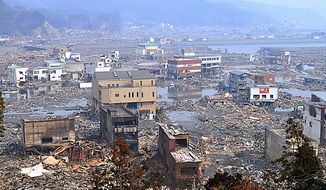 Houses and infrastructure devastated by a strong earthquake and tsunami are seen in Otsuchi, in Japan&#39;s Iwate Prefecture, on Monday, March 14, 2011, three days after northeastern coastal towns were devastated by the earthquake and tsunami. (AP Photo/Kyodo News) 