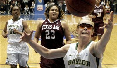 Baylor&#39;s Melissa Jones (5) reaches for a rebound as Texas A&amp;M&#39;s Danielle Adams (23) and Baylor&#39;s Brooklyn Pope look on during the first half of an NCAA college basketball game in the championship game at the Big 12 Conference women&#39;s tournament on Saturday, March 12, 2011, in Kansas City, Mo. (AP Photo/Jeff Roberson)