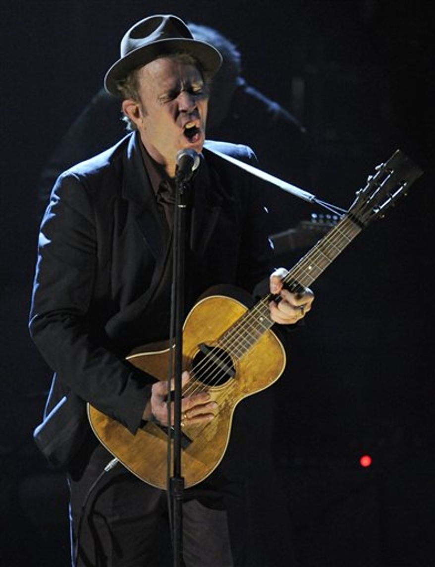 Inductee Tom Waits performs at the Rock and Roll Hall of Fame induction ceremony, Monday, March 14, 2011, in New York. (AP Photo/Evan Agostini)