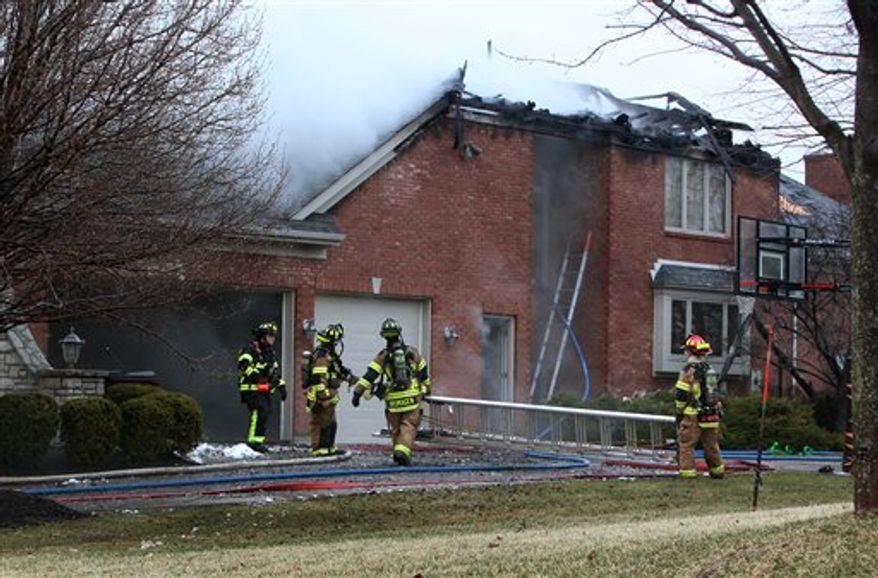 Mason firefighters work at the home of Cincinnati Bengals defensive end Antwan Odom after a fire early Tuesday, March 15, 2011 caused extensive damage at the home, according to Warren County emergency communication reports. Fire officials in the city of Mason north of Cincinnati say the defensive end and his family were out of town at the time. (AP Photo/Cincinatti Enquirer, Carrie Cochran) MANDATORY CREDIT