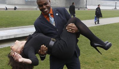 Former Olympic champions Carl Lewis and Nadia Comaneci pose for the cameras in front of London's Tower Bridge as they take part in a media event to launch 500 days to the start of the London 2012 games and the beginning of the sale of 6.6 million tickets for the games in London, Tuesday, March 15, 2011. (AP Photo/Alastair Grant)