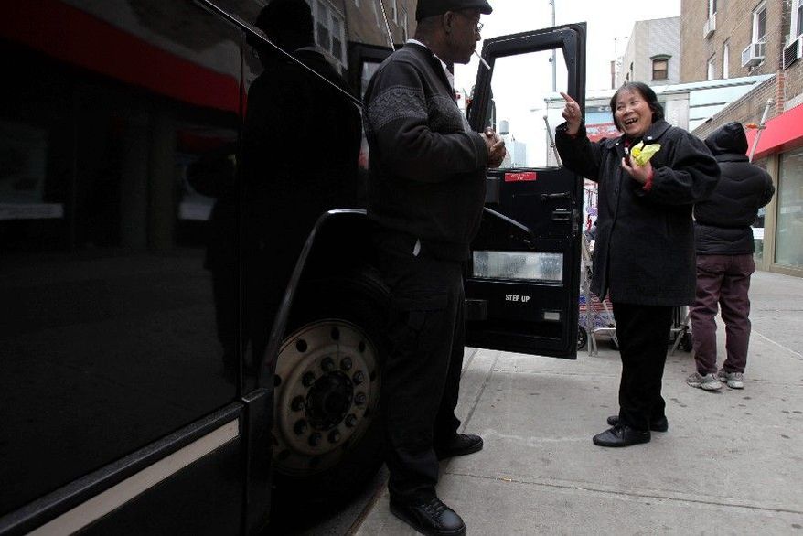 A woman talks with the driver before boarding a bus in Manhattan's Chinatown for a trip to a Connecticut casino. Her trip Tuesday was canceled after a fatal crash, but thousands of Chinese New Yorkers take buses every day to gamble in nearby states. (Associated Press)