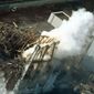 DANGER: Thick smoke billows from the No. 3 unit of the Fukushima Dai-ichi nuclear power plant in Japan. A nearly completed new power line could restore cooling systems to the tsunami-damaged structure, its operator said Thursday. (Associated Press)