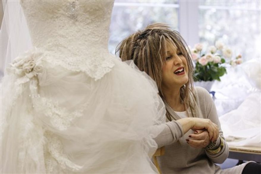 Designer dressmaker Elizabeth Emmanuel, who designed the wedding gown for the late Princess Diana for her 1981 wedding to Britain's Prince Charles, talks about the pressures of coping with the commission to design a royal wedding dress, to the Associated Press in London, Tuesday, March 15, 2011. Emmanuel says that the mystery designer for the wedding dress to be worn by Kate Middleton for her royal wedding to Prince William and Kate Middleton is probably more than a bit anxious right now, as the April 29 date for wedding day approaches. (AP Photo/Sang Tan)