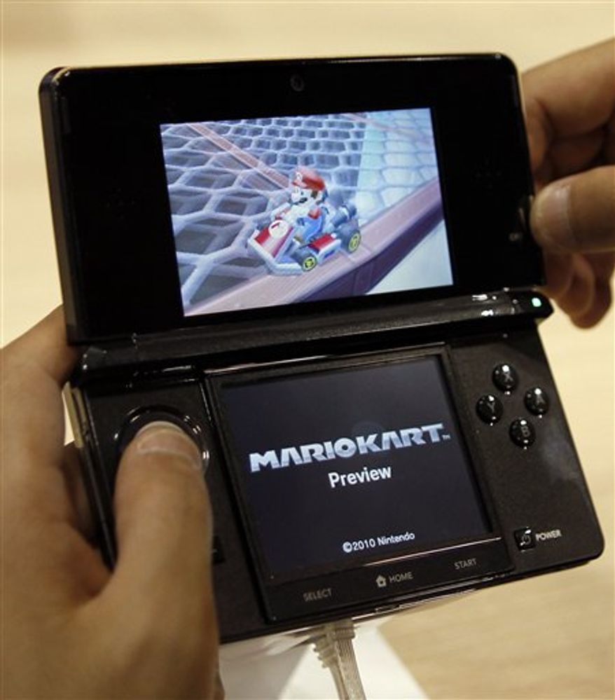 FILE - In this Sept. 29, 2010 file photo, a visitor operates a Nintendo 3DS featuring 3-D imagery during a press conference by Nintendo Co. Nintendo Corp. has warned that the 3-D screen on its new 3DS handheld game device shouldn't be used by children 6 or younger because it may harm their immature vision.(AP Photo/Shuji Kajiyama, file)