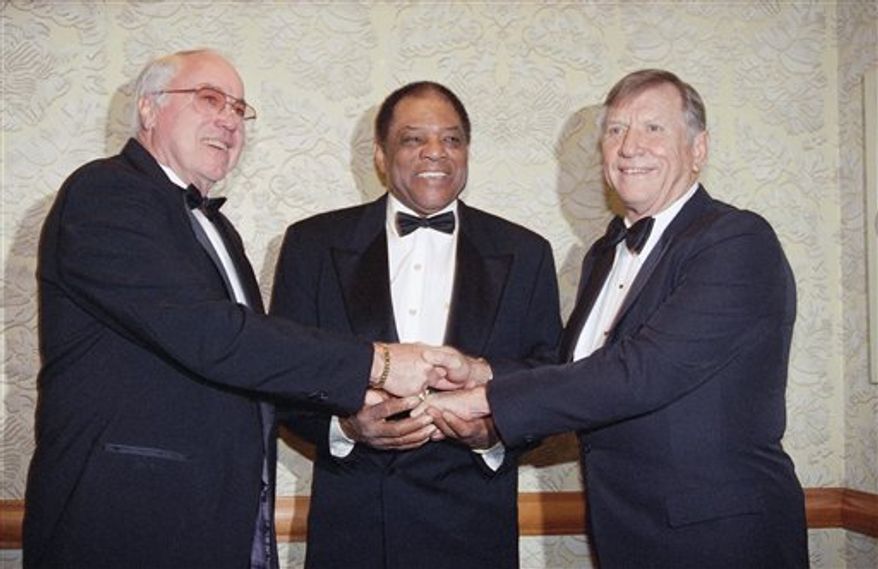 FILE - This Jan. 22, 1995, file photo shows from left, Duke Snider, Willie Mays and Mickey Mantle joining hands as they pose at the New York chapter dinner of the Baseball Writers Association, in New York. The Hall will honor "Talkin' Baseball" composer and singer Terry Cashman this summer as part of induction weekend, 30 years after his song became a ballpark favorite. (AP Photo/Eric Miller, File)