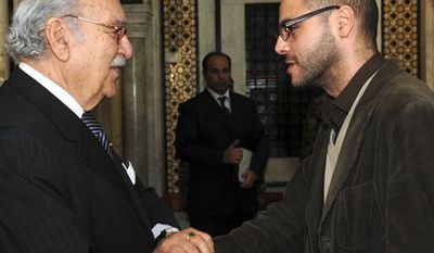 This Jan.18 2011 photo shows former blogger and now Tunisian deputy minister in charge of Youth and Sports, Slim Amamou, right, shaking hands with Tunisian interim President Fouad Mebazaa, in Tunis. At the height of the Tunisian uprising, Zine El Abidine Ben Ali&#39;s security agents repeatedly shut down websites and arrested, even tortured, some of the bloggers helping drive the protests against him. But two months after Ben Ali&#39;s fall, the caretaker government has embraced the very tools its predecessor tried to destroy. It has lifted web censorship. Key ministries now communicate with citizens through Facebook. (AP PHOTO/Hassene Dridi)
