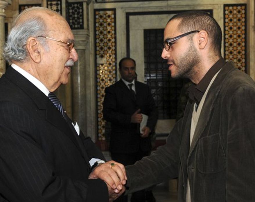 This Jan.18 2011 photo shows former blogger and now Tunisian deputy minister in charge of Youth and Sports, Slim Amamou, right, shaking hands with Tunisian interim President Fouad Mebazaa, in Tunis. At the height of the Tunisian uprising, Zine El Abidine Ben Ali's security agents repeatedly shut down websites and arrested, even tortured, some of the bloggers helping drive the protests against him. But two months after Ben Ali's fall, the caretaker government has embraced the very tools its predecessor tried to destroy. It has lifted web censorship. Key ministries now communicate with citizens through Facebook. (AP PHOTO/Hassene Dridi)
