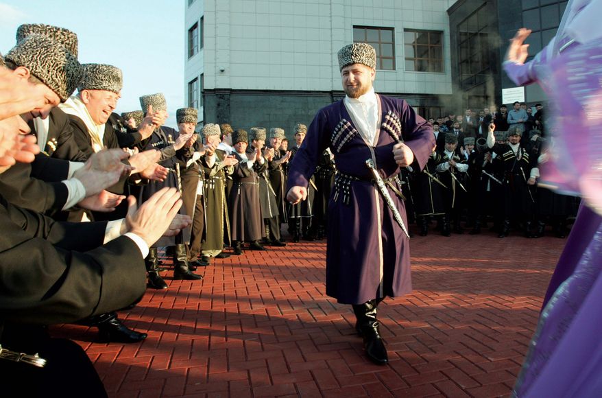 ** FILE ** Ramzan Kadyrov, clad in a traditional Chechen costume, dances in Chechnya's provincial capital, Grozny. He has described himself as a protector of Russia's unity, but Chechens live in fear of his authoritarian rule. (Associated Press)