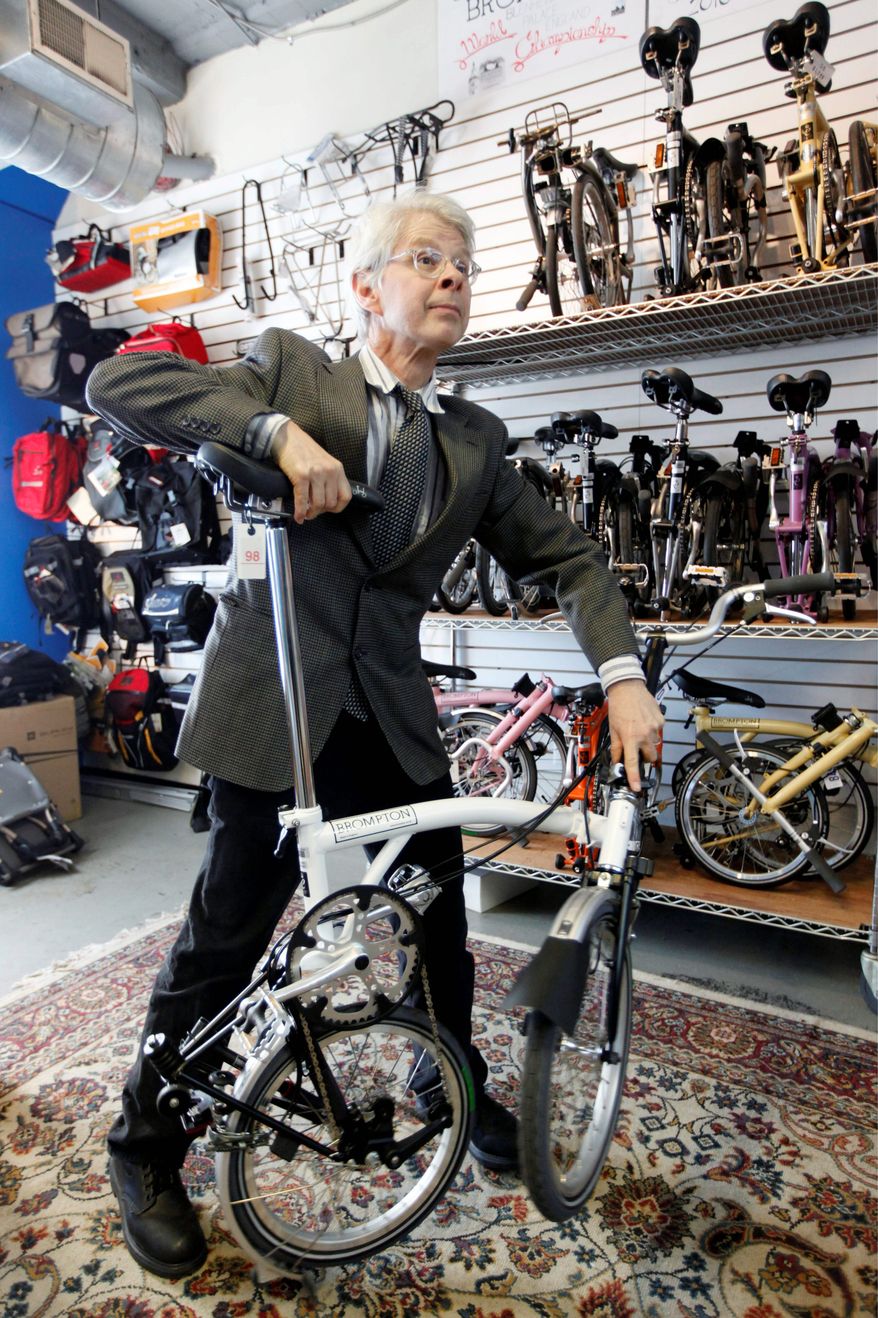 At Trophy Bikes in Philadelphia, Mr. McGettigan demonstrates the three-step fold of a Brompton bicycle that takes about 15 seconds. (Associated Press)