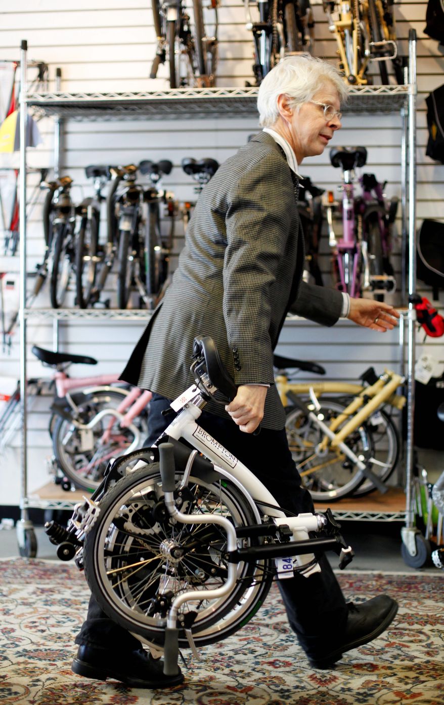 "It's light, it's fast. It has a quirky charm. It's tanklike but incredibly high-tech," Michael McGettigan says about the Brompton bicycle. His shop was one of the first in the U.S. to sell the British bikes. (Associated Press)