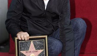 Canadian singer Bryan Adams is honored with a star on the Hollywood Walk of Fame in Los Angeles on Monday, March 21, 2011. (AP Photo/Damian Dovarganes)