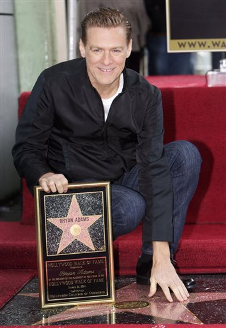 Canadian singer Bryan Adams is honored with a star on the Hollywood Walk of Fame in Los Angeles on Monday, March 21, 2011. (AP Photo/Damian Dovarganes)