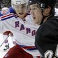 New York Rangers&#39; Ryan McDonagh, left, and Pittsburgh Penguins&#39; Matt Cooke work along the boards in the second period of the NHL hockey game, Sunday, March 20, 2011 in Pittsburgh. The Rangers won 5-2. (AP Photo/Keith Srakocic)
