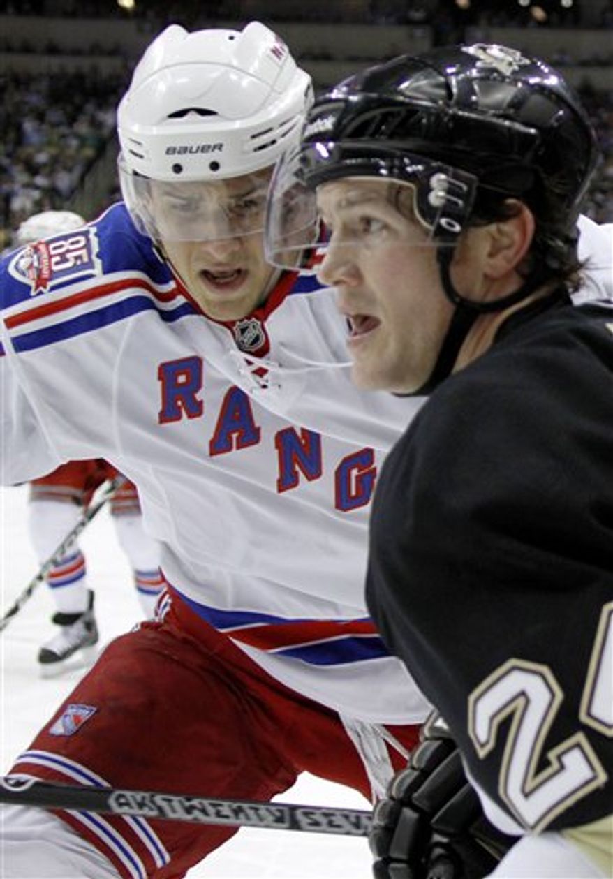 New York Rangers&#39; Ryan McDonagh, left, and Pittsburgh Penguins&#39; Matt Cooke work along the boards in the second period of the NHL hockey game, Sunday, March 20, 2011 in Pittsburgh. The Rangers won 5-2. (AP Photo/Keith Srakocic)