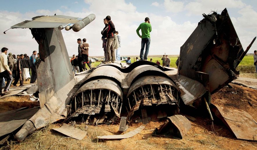 Libyans inspect the wreckage of a U.S. F-15E fighter jet after it crashed Tuesday in a field east of Benghazi. Both crew members ejected and were rescued. The U.S. Africa Command blamed mechanical failure for the loss of the aircraft. (Associated Press)