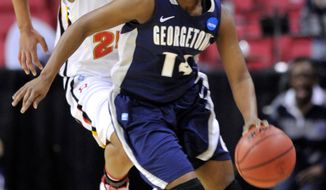 Georgetown&#39;s Sugar Rodgers steals the ball from Maryland&#39;s Alyssa Thomas during the first half of a second-round game in the NCAA women&#39;s college basketball tournament Tuesday, March 22, 2011, in College Park, Md. (AP Photo/Gail Burton)