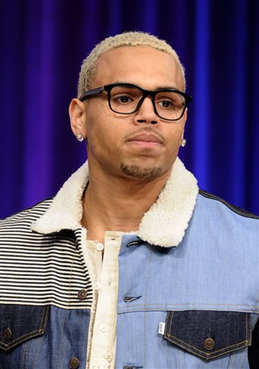 From left, BET hosts Terence Jackson and Rocsi talk with singer Chris Brown on BET's 106 & Park show in New York, on Monday, March 21, 2011. (AP Photo/Peter Kramer)