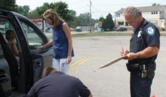 Trained professionals inspect and install a car seat in Erie County, New York.