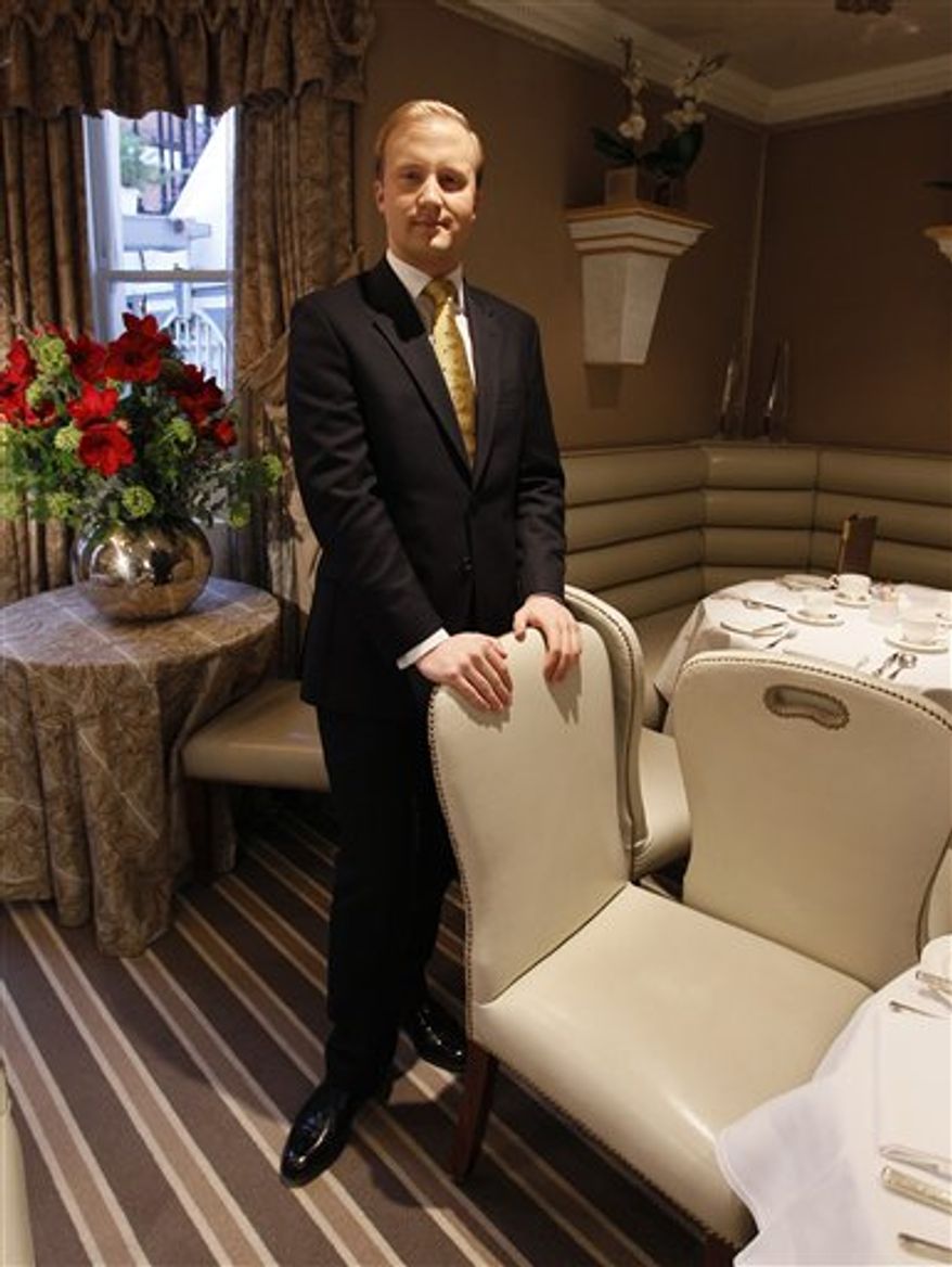 This is a Tuesday, March, 4, 2011 image of William Hanson an expert on protocol who gives lesson on proper behaviour around the world, poses during an interview  in London.  Don't give the queen a friendly hug and don't tweet from the church. That's just the start of the advice being offered to those attending Britain's April 29 royal wedding. (AP Photo/Alastair Grant)