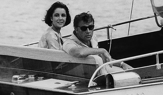 In this June 15, 1962 file photo, Richard Burton and Elizabeth Taylor arrive in a motor launch at the small town Porto d&#x27;Ischia, on the isle of Ischia in the Gulf of Naples, Italy for the shooting of some scenes of &quot;Cleopatra&quot;. Publicist Sally Morrison says Taylor died Wednesday, March 23, 2011 in Los Angeles of congestive heart failure at age 79. (AP Photo/Girolamo, File)