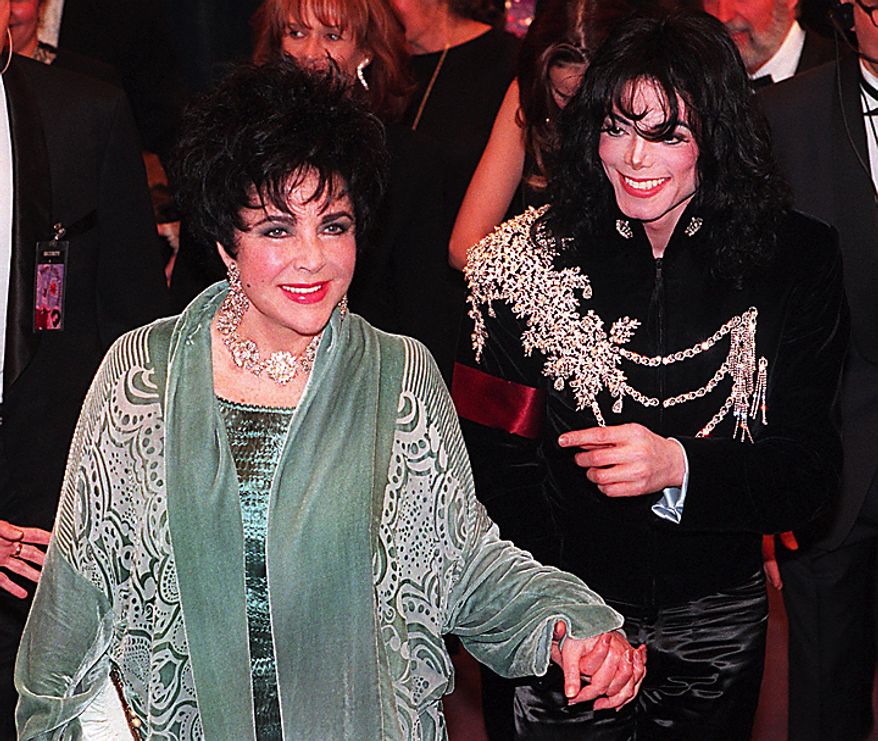 This Feb. 16, 1997 file photo shows Elizabeth Taylor arriving with Michael Jackson at the Pantages Theater in Los Angeles for her birthday celebration. Publicist Sally Morrison says the actress died Wednesday, March 23, 2011 in Los Angeles of congestive heart failure at age 79. (AP Photo/Chris Pizzello, File)
