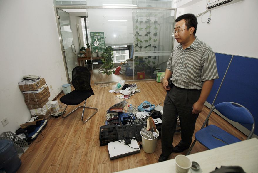 Chinese lawyer Jiang Tianyong scans the half-empty office of the Gongmeng rights group's legal research center after it was closed in July 2009 by Chinese authorities. The last time he was seen, police were throwing him into a van in February while visiting his brother's house near Beijing. "None of them will tell me anything about why he was taken away or where he has been taken to," his wife, Jin Bianling, said. "I worry about him all the time. What if the police are torturing him?" (Associated Press)