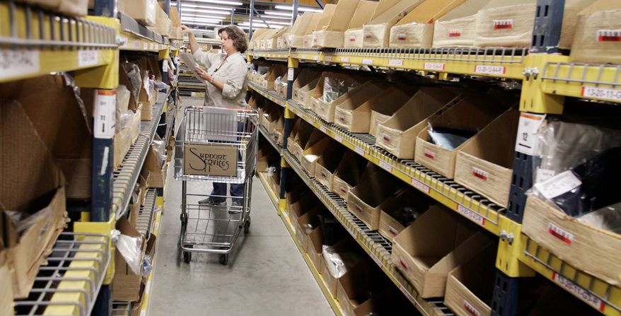 Sandy Bickford of Standish, Maine, retrieves merchandise for shipping at a facility at L.L. Bean in Freeport, Maine. A spokesman at the outdoors and clothing retailer announced that the company is offering permanent, no-strings-attached free shipping. (Associated Press)