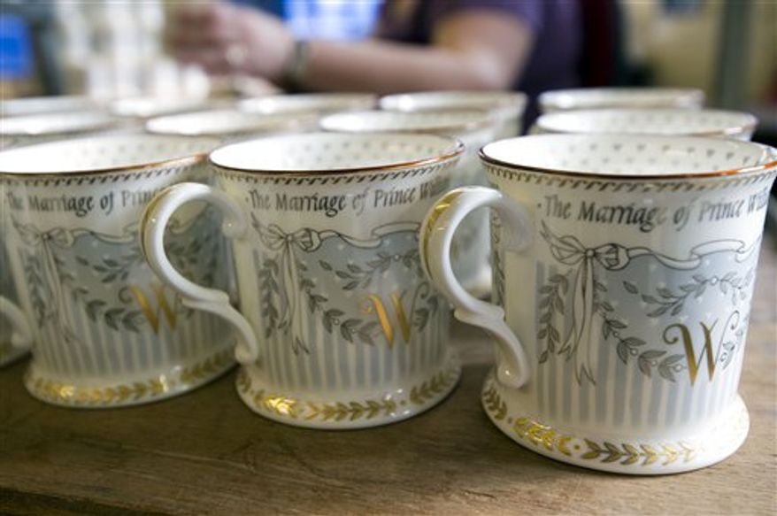 A limited edition of commemorative cups is being finished, as part of a limited edition of Official Royal Wedding Commemorative China collection. Official pottery commemorating the royal wedding between Britain's HRH Prince William and Catherine Middleton, is being hand finished at a factory in Stoke-on-Trent, England, Wednesday March 23, 2011. The official commemorative fine china, named The Royal Collection, including various designs of cups, pill boxes and plates is being completed for the royal wedding on April 29, 2011.(AP Photo)