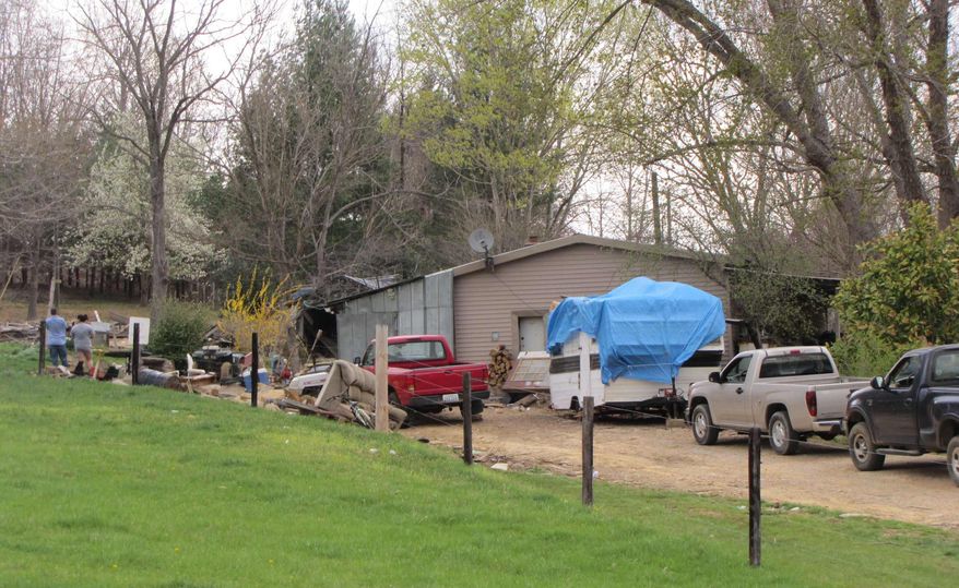 Family and friends of the victims gather outside the mobile home in rural Metcalfe County, Ky., on Wednesday, March 23, 2011, where of a couple was shot and killed by the 15-year-old boy who was staying with them. (AP Photo/The Lexington Herald-Leader, Bill Estep)