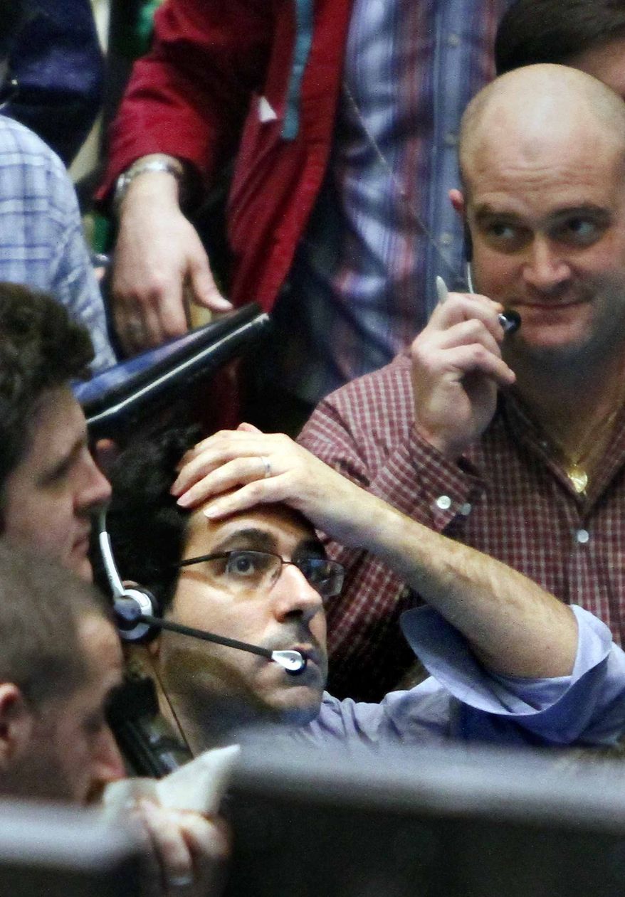 ** FILE ** In this file photo taken March 11, 2011, traders of crude oil and natural gas react during early trading at the New York Mercantile Exchange. Oil prices moved up closer to $106 a barrel on Friday, March 25, 2011, as political upheaval in the Middle East and signs of strong global demand kept crude near two-year highs. (AP Photo/Bebeto Matthews, file)