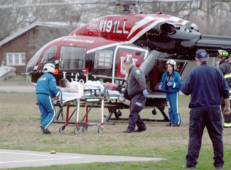 A student is wheeled to a waiting Lifeline helicopter Friday, March 25, 2011, at West Middle School in Martinsville, Ind. A person was shot Friday at the middle school in south-central Indiana and a suspect is in custody, state police said. (AP Photo/Mooresville-Decatur Times, Keith Rhoades)