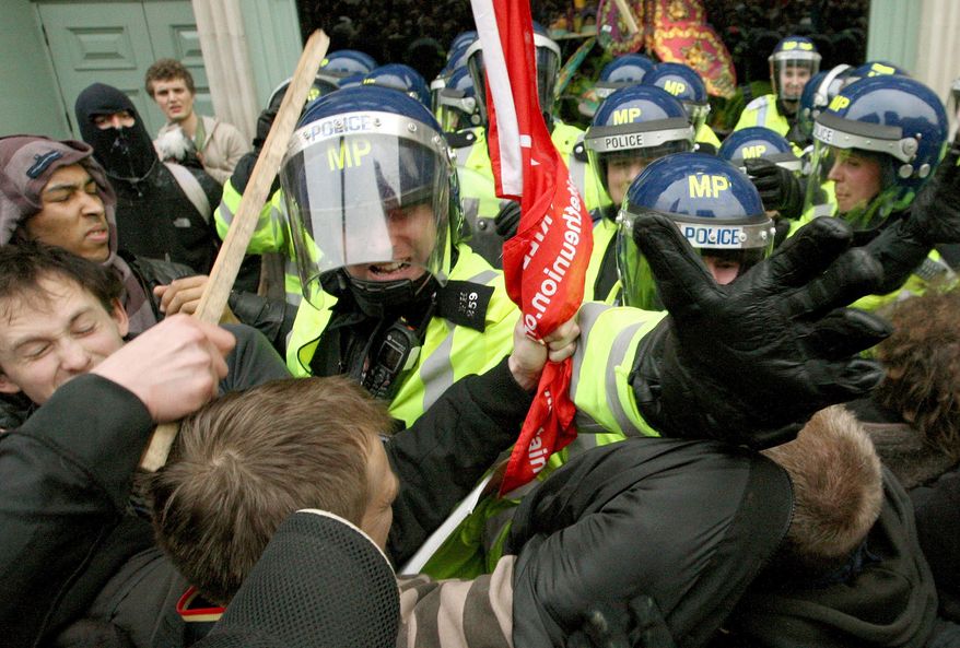 Police clash with protestors outside the famous Fortnum & Mason store on Piccadilly in London during a march against government spending cuts, in central London Saturday March 26, 2011. Tens of thousands of mostly peaceful demonstrators streamed into central London on Saturday to march against government budget cuts, with a small breakaway group smashing its way into a bank, breaking windows and spray painting logos on the walls. (AP Photo/Dominic Lipinski/PA)