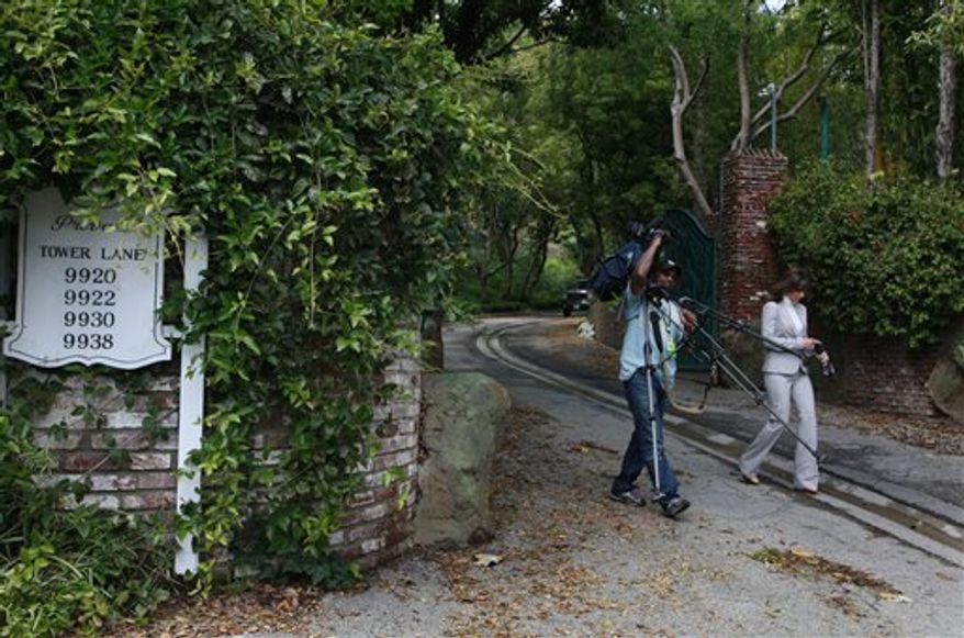A television news crew leaves the site of a proposed mega-mansion in the Benedict Canyon area of Beverly Hills, Calif., Tuesday March 22, 2011. Wealthy Los Angeles residents are banding together to fight plans for this mega-mansion that would create a compound roughly the size of the famed Hearst Castle. AP Photo/Nick Ut)