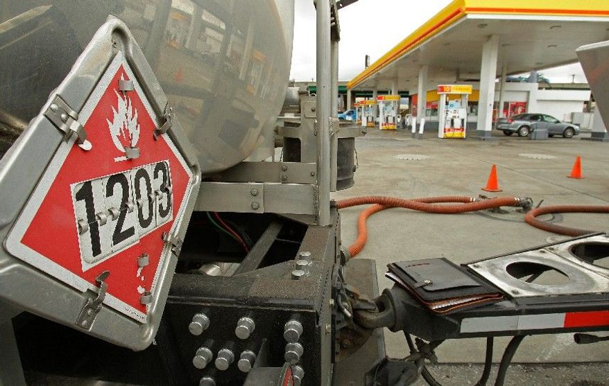 ASSOCIATED PRESS PHOTOGRAPHS
A truck fuels up a gasoline station in Oakland, Calif., as prices empty wallets a little more. February's increase in consumer spending and income largely went to cover higher gas prices.