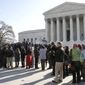People line up outside the U.S. Supreme Court in Washington on Tuesday, March 29, 2011, to attend a hearing in a class-action suit by female employees of Wal-Mart. (AP Photo/Jacquelyn Martin)