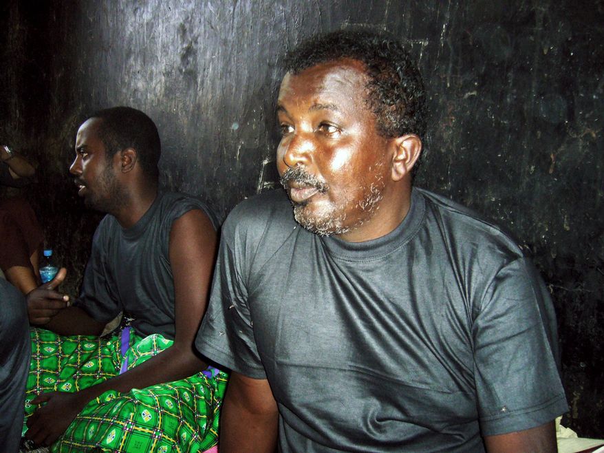 Omar Abdullahi Abdi sits in a prison in the Somaliland port city of Berbera. He claims he is a fisherman but the Somaliland coast guard accuse him of being a pirate. "I'm innocent. We are all innocent," he said, referring to the others who were arrested. (Associated Press)
