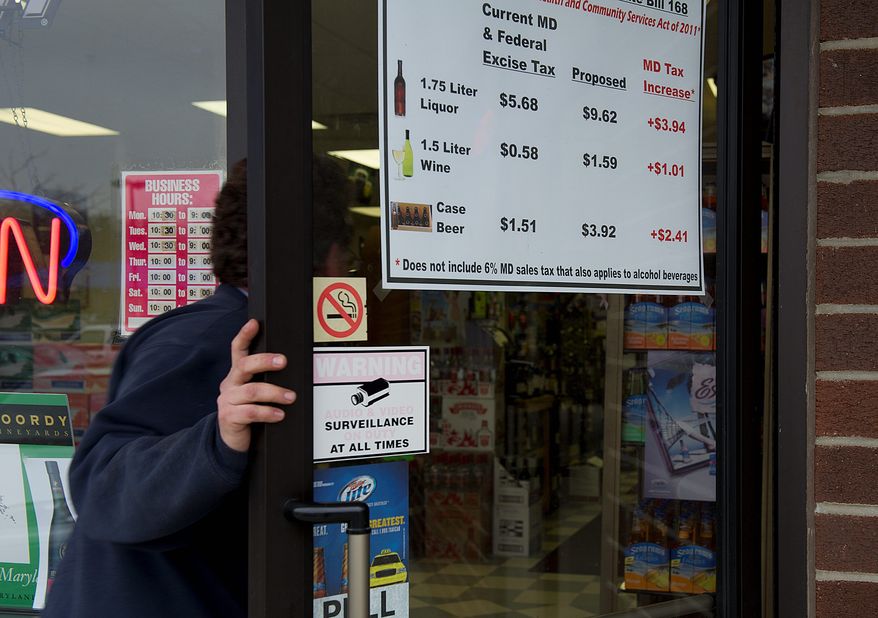 A customer enters the PM Wine & Spirits store in Pasadena, Md. on Wednesday. The store has posted a sign on its front door letting customers know that a proposed bill would add more taxes to all liquor sales in the state. (Barbara L. Salisbury/The Washington Times)