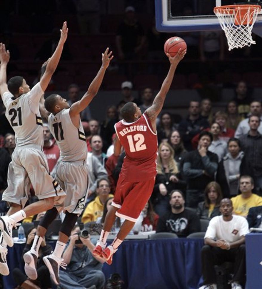 Alabama's Trevor Releford (12) goes up against Colorado's Andre Roberson (21) and Cory Higgins to score the winning goal in the final seconds of a semifinal in the NIT college basketball tournament, Tuesday, March 29, 2011, at Madison Square Garden in New York. Alabama defeated Colorado 62-61. (AP Photo/Mary Altaffer)