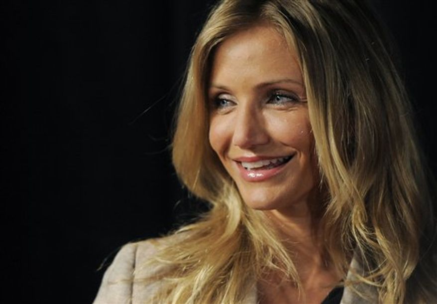 Actress Cameron Diaz, recipient of CinemaCon's Female Star of the Year award, poses in front of a poster for her upcoming film "Bad Teacher" at CinemaCon 2011 on Wednesday, March 30, 2011, in Las Vegas. (AP Photo/Chris Pizzello)