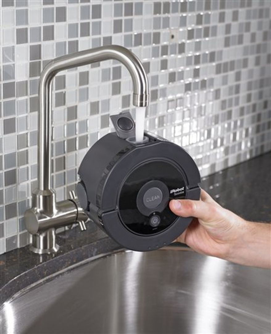 In this product photo provided by iRobot Corp., the Scooba 230, is shown. The engineers at iRobot Corp. continue to fill the world with wondrous robots, the latest being a compact floor-washing machine called the Scooba 230.(AP Photo/iRobot Corp.) NO SALES