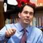**FILE** Republican Wisconsin Gov. Scott Walker answers news media questions March 31 after a circuit judge forced him to halt implementing a law that cripples collective bargaining. (Associated Press)