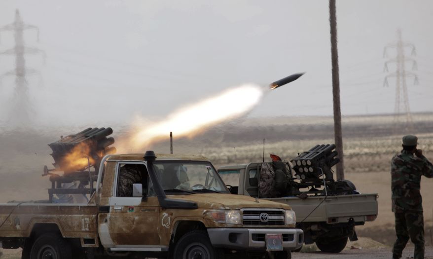 Libyan rebels fire rocket launchers toward pro-Gadhafi forces, along the front line outside the eastern town of Brega, Libya Thursday, March 31, 2011. Libya conceded Thursday that Foreign Minister Moussa Koussa had resigned but claimed that it was a personal decision driven by health problems, not a sign that the embattled regime is cracking at the highest levels. (AP Photo/Nasser Nasser)