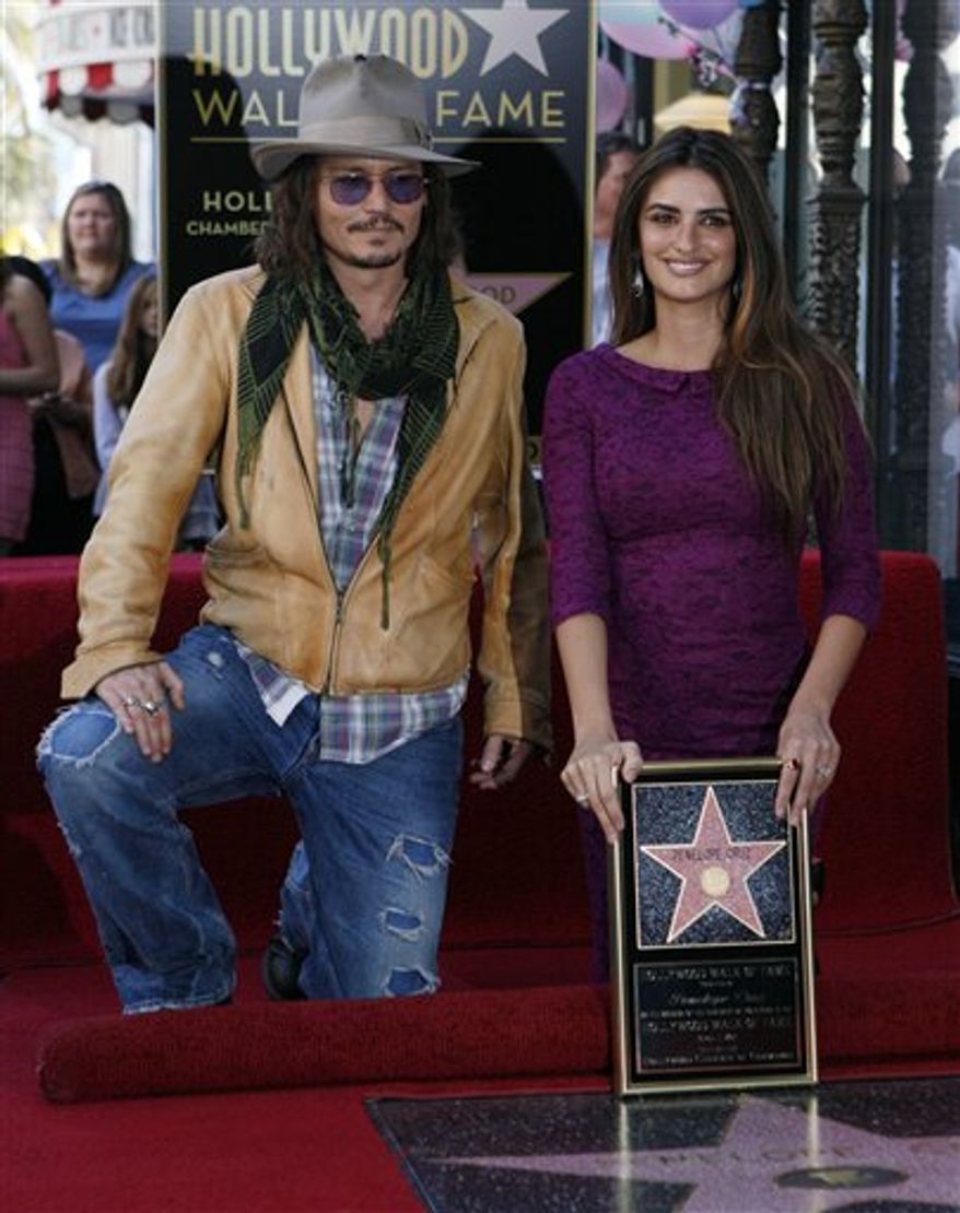 Actor Johnny Depp, left, poses with Spanish actress Penelope Cruz, as she is honored with a star on the Hollywood Walk of Fame on Friday, April 1, 2011 in Los Angeles. (AP Photo/Damian Dovarganes)