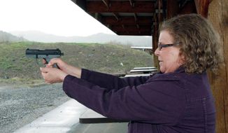 Cynthia Willis visits a firing range in White City, Ore. She is suing the Jackson County sheriff over the denial of a concealed-handgun permit after acknowledging that she uses marijuana to treat arthritis and muscle spasms. (Associated Press)