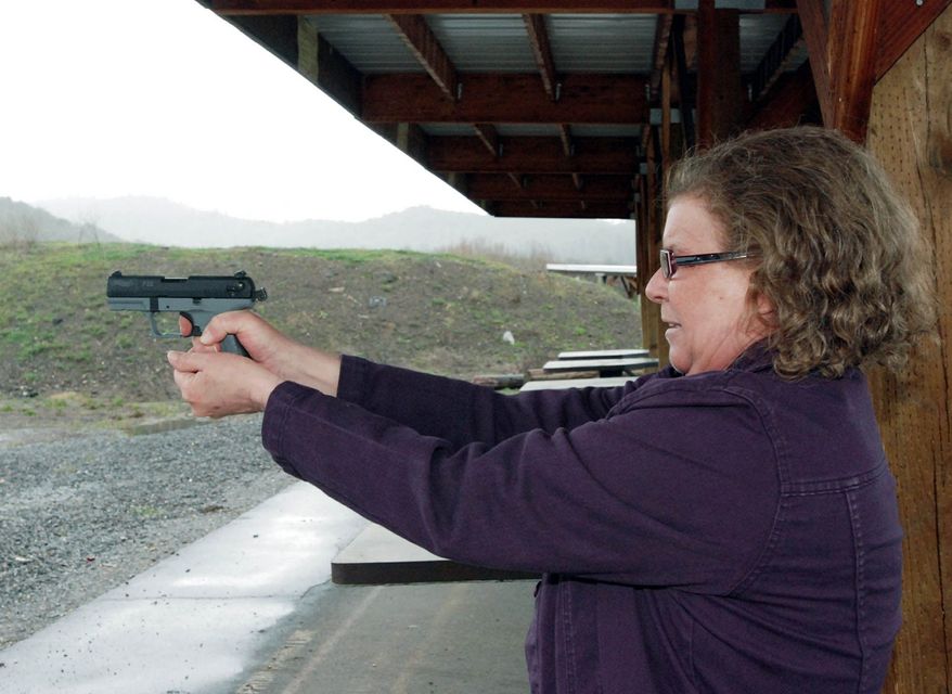 Cynthia Willis visits a firing range in White City, Ore. She is suing the Jackson County sheriff over the denial of a concealed-handgun permit after acknowledging that she uses marijuana to treat arthritis and muscle spasms. (Associated Press)