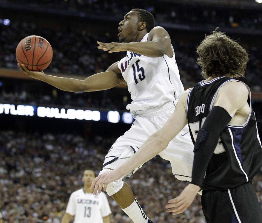 Connecticut's Kemba Walker shoots as Butler's Matt Howard defends during the second half of the men's NCAA Final Four college basketball championship game Monday, April 4, 2011, in Houston. (AP Photo/Eric Gay)